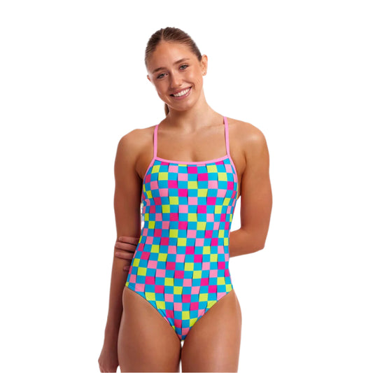 Woman wearing a colorful checkered swimsuit on a white background