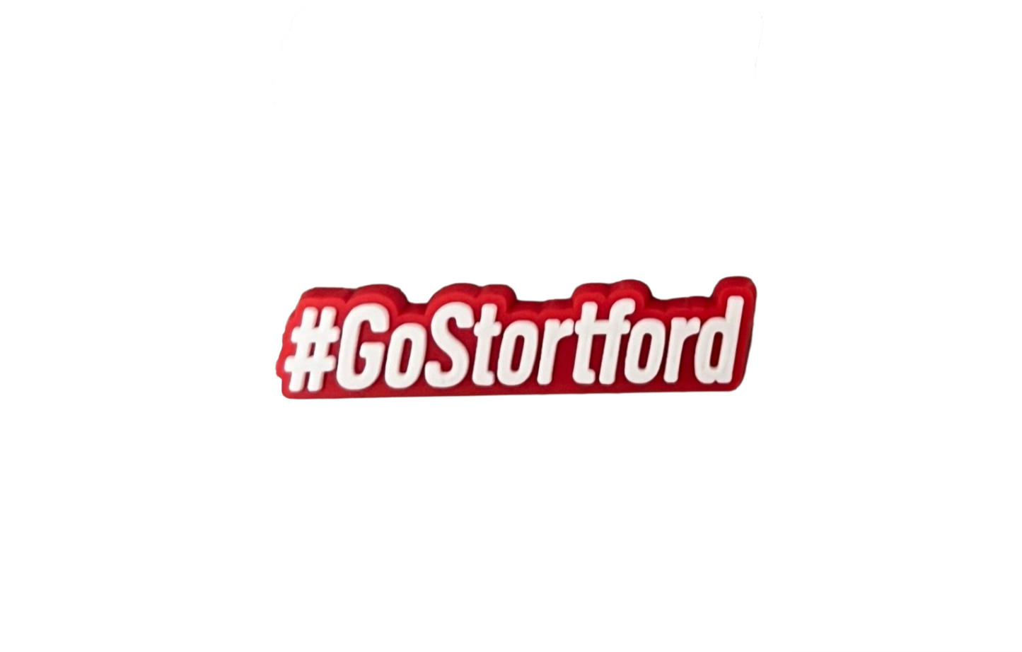 The image features the Bishops Stortford Swimming Club Shoe Charm - Go Stortford (White) by All4Swim, with "#GoStortford" in bold white text and a red outline—a fun poolside accessory for fans.